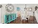 Bright dining area with white chairs and a teal accent cabinet at 222 Ingram Rd, Statesville, NC 28625