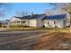 Side view of ranch home showcasing a metal roof and large yard at 222 Ingram Rd, Statesville, NC 28625