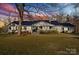 House exterior at dusk, metal roof, landscaping, and porch at 222 Ingram Rd, Statesville, NC 28625