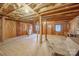 Unfinished basement with exposed beams, brick floor, and stone fireplace at 2452 Nc 182 Hwy, Lincolnton, NC 28092