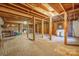 Unfinished basement with exposed beams, brick floor, and stone fireplace at 2452 Nc 182 Hwy, Lincolnton, NC 28092