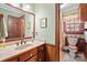 Bathroom with light green walls, wooden vanity, and a toilet at 2452 Nc 182 Hwy, Lincolnton, NC 28092