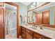 Bathroom with light green walls, wooden vanity, and a bathtub at 2452 Nc 182 Hwy, Lincolnton, NC 28092