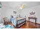 Bedroom with blue and white bedding, wooden floors, and a rocking chair at 2452 Nc 182 Hwy, Lincolnton, NC 28092