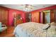 Bedroom with red walls, wood floors, and built-in wooden cabinets and dresser at 2452 Nc 182 Hwy, Lincolnton, NC 28092