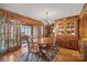 Dining area features wood table and chairs, access to sunroom, and built-in hutch at 2452 Nc 182 Hwy, Lincolnton, NC 28092