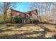 Side view of house highlighting sunroom and landscaping at 2452 Nc 182 Hwy, Lincolnton, NC 28092