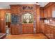 Kitchen with wood cabinets, brick accent wall, and oven at 2452 Nc 182 Hwy, Lincolnton, NC 28092