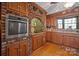 Kitchen with wood cabinets, brick accent wall, and oven at 2452 Nc 182 Hwy, Lincolnton, NC 28092