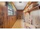 Bright laundry room with wood paneling, built-in cabinets, and tiled floor at 2452 Nc 182 Hwy, Lincolnton, NC 28092