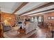 Living room boasts exposed wooden beams, a brick fireplace, and hardwood floors at 2452 Nc 182 Hwy, Lincolnton, NC 28092