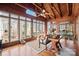 Bright sunroom with wood ceiling, walls, and floors, featuring many windows and wooded views at 2452 Nc 182 Hwy, Lincolnton, NC 28092