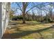 Large backyard with grass and mature trees at 2717 Madison Oaks Ct, Charlotte, NC 28226