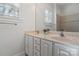 Bathroom with double sinks, white cabinets, and a shower at 2717 Madison Oaks Ct, Charlotte, NC 28226