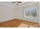 Well-lit bedroom featuring hardwood floors and a large window at 2717 Madison Oaks Ct, Charlotte, NC 28226