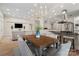 Bright dining room features a wood table and chandelier, open to the living area at 2717 Madison Oaks Ct, Charlotte, NC 28226