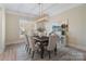 Formal dining room with hardwood floors, chandelier, and neutral decor at 2717 Madison Oaks Ct, Charlotte, NC 28226