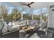 Relaxing screened porch with comfortable seating and ceiling fan at 2717 Madison Oaks Ct, Charlotte, NC 28226