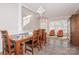 Bright dining room with a wooden table and view to the kitchen at 4115 Stuart Ln, Indian Land, SC 29707