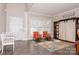 Living room with orange armchairs, a barn door cabinet, and wood floors at 4115 Stuart Ln, Indian Land, SC 29707