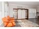 Living room with orange armchairs and a rustic barn door cabinet at 4115 Stuart Ln, Indian Land, SC 29707