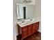 Double vanity bathroom with large mirror and dark wood cabinets at 5121 Stone Park Dr, Charlotte, NC 28269