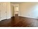 Spacious bedroom with hardwood floors and access to hallway at 5121 Stone Park Dr, Charlotte, NC 28269