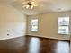 Spacious bedroom with hardwood floors and two windows at 5121 Stone Park Dr, Charlotte, NC 28269