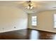 Spacious bedroom with hardwood floors and two windows at 5121 Stone Park Dr, Charlotte, NC 28269