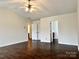 Spacious primary bedroom with dark wood floors and ceiling fan at 5121 Stone Park Dr, Charlotte, NC 28269