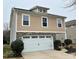 Two-story house, tan siding, white garage doors at 5121 Stone Park Dr, Charlotte, NC 28269