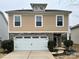 Tan two-story house with white double garage and stone accents at 5121 Stone Park Dr, Charlotte, NC 28269