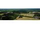 Aerial view showing expansive property with a pond and surrounding woodlands at 6050 Mcconnells Hwy, McConnells, SC 29726