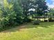 Spacious backyard with mature trees and a covered structure at 6050 Mcconnells Hwy, McConnells, SC 29726