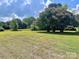 Spacious front yard with lush grass and mature trees at 6050 Mcconnells Hwy, McConnells, SC 29726