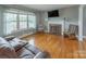 Spacious living room featuring hardwood floors, fireplace, and large windows at 6050 Mcconnells Hwy, McConnells, SC 29726