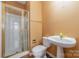 Cozy full bathroom includes a shower and a modern pedestal sink at 6654 Kingbird Ct, Charlotte, NC 28215