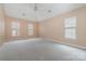 Spacious bedroom with neutral walls, plush carpet, and multiple windows, offering lots of natural light at 6654 Kingbird Ct, Charlotte, NC 28215