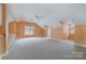 Large bonus room with vaulted ceilings and plush carpet; ideal for various activities at 6654 Kingbird Ct, Charlotte, NC 28215