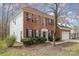 Charming two-story brick home featuring black shutters, mature trees and a well-maintained lawn at 6654 Kingbird Ct, Charlotte, NC 28215