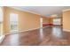 Spacious living room with wood floors, neutral paint, and ample natural light from windows at 6654 Kingbird Ct, Charlotte, NC 28215