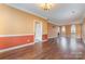 Spacious living room with wood floors, neutral paint, and ample natural light from arched windows at 6654 Kingbird Ct, Charlotte, NC 28215