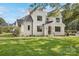 Elegant two-story home showcasing a white brick facade and manicured lawn at 669 Dogwood Ln, Davidson, NC 28036