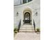 Stunning front entry with arched doorway, brick facade, and landscaping at 669 Dogwood Ln, Davidson, NC 28036