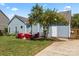 Cozy backyard features a seating area and mature tree at 8523 Albury Walk Ln, Charlotte, NC 28277