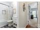 Hallway view of a full bathroom with subway tile shower and a toilet at 8523 Albury Walk Ln, Charlotte, NC 28277