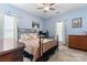 This cozy bedroom has a ceiling fan and a metal frame bed at 8523 Albury Walk Ln, Charlotte, NC 28277