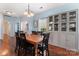 Dining room boasts hardwood floors, a classic chandelier, and a glass display cabinet at 8523 Albury Walk Ln, Charlotte, NC 28277