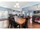 Open dining area shows hardwood floors, a classic chandelier, & an open concept floor plan at 8523 Albury Walk Ln, Charlotte, NC 28277