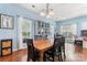 This dining area shows hardwood floors, a classic chandelier, and cabinet at 8523 Albury Walk Ln, Charlotte, NC 28277